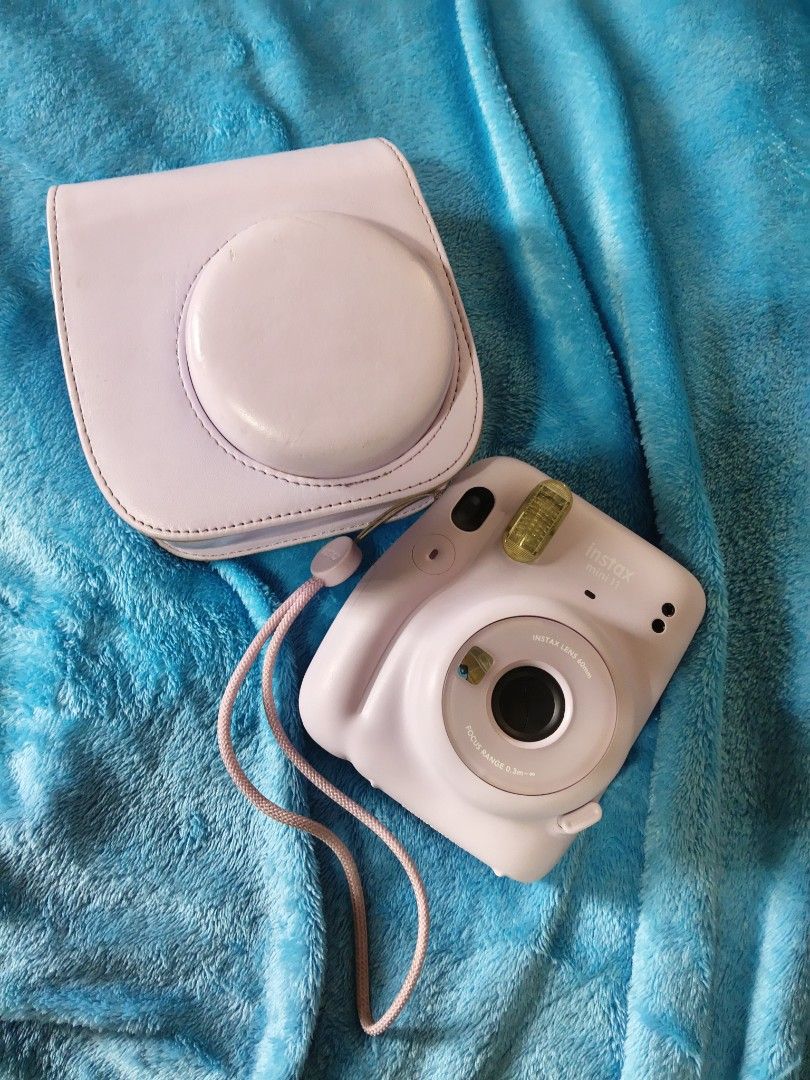 Fujifilm Instax Mini 11 Pastel Purple with Case (Category: Cameras) located in Manila. Submitted by artsylove24 (Listing ID 1466797321, Image 1). Description: - Model: Pastel purple Fujifilm instant camera - Condition: Tested and fully working (lens and flash checked) - Included: Matching leatherette case and wrist strap - Power: AA batteries already loaded inside - Perfect for: Parties, trips, and capturing memories.