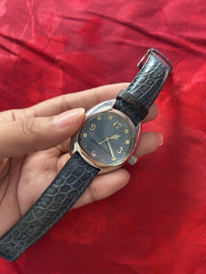Gerald Charles Renaissance Blue Dial Leather Strap Watch (Category: Luxury Watches) located in Taguig. Submitted by mariachristina25 (Listing ID 1466844676, Image 2). Description: - Brand/Model: Gerald Charles Renaissance - Design: Distinctive asymmetrical stainless steel case designed by Gérald Genta - Dial: Textured blue dial with date window at the 6 o'clock position - Movement: Manual winding - Strap: Matching blue leather strap with engraved
