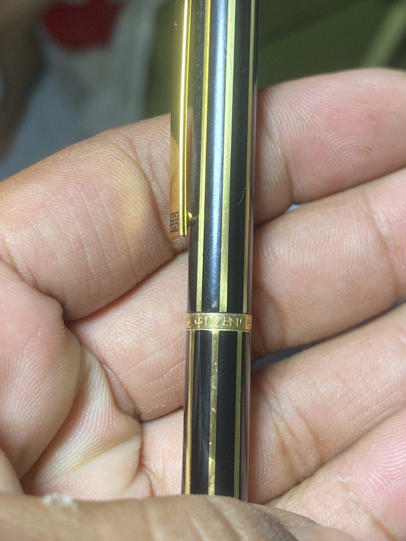 Givenchy Black and Gold Ballpoint Pen (Category: Stationery & School Supplies) located in General Trias. Submitted by mangu_ukay (Listing ID 1466914572, Image 3). Description: - Authentic vintage Givenchy luxury ballpoint pen - Sleek black finish with elegant gold vertical stripes and gold trim - Iconic Givenchy 4G logo featured on the clip and cap top - Engraved Givenchy branding on the middle ring and refill cartridge - Reliable refillable twis