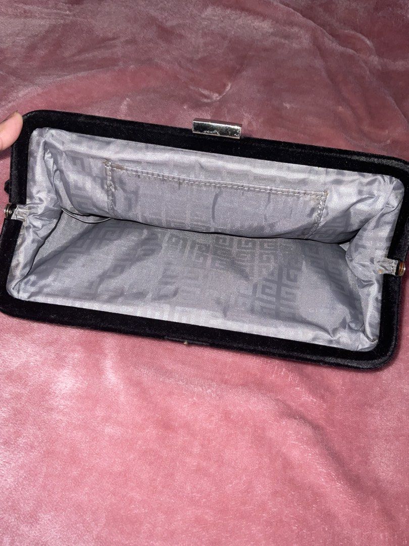 Givenchy Parfums Black Velvet Clutch Bag (Category: Luxury Bags & Wallets) located in Mangatarem. Submitted by rj4mmm (Listing ID 1466830920, Image 2). Description: - Brand: Givenchy Parfums - Material: Soft black velvet exterior with a structured frame - Clasp: Silver-tone kiss-lock with engraved Givenchy logo - Interior: Silver lining featuring a repeating monogram pattern with one slip pocket - Condition: 9.5/10 minimal lints visible (can be r
