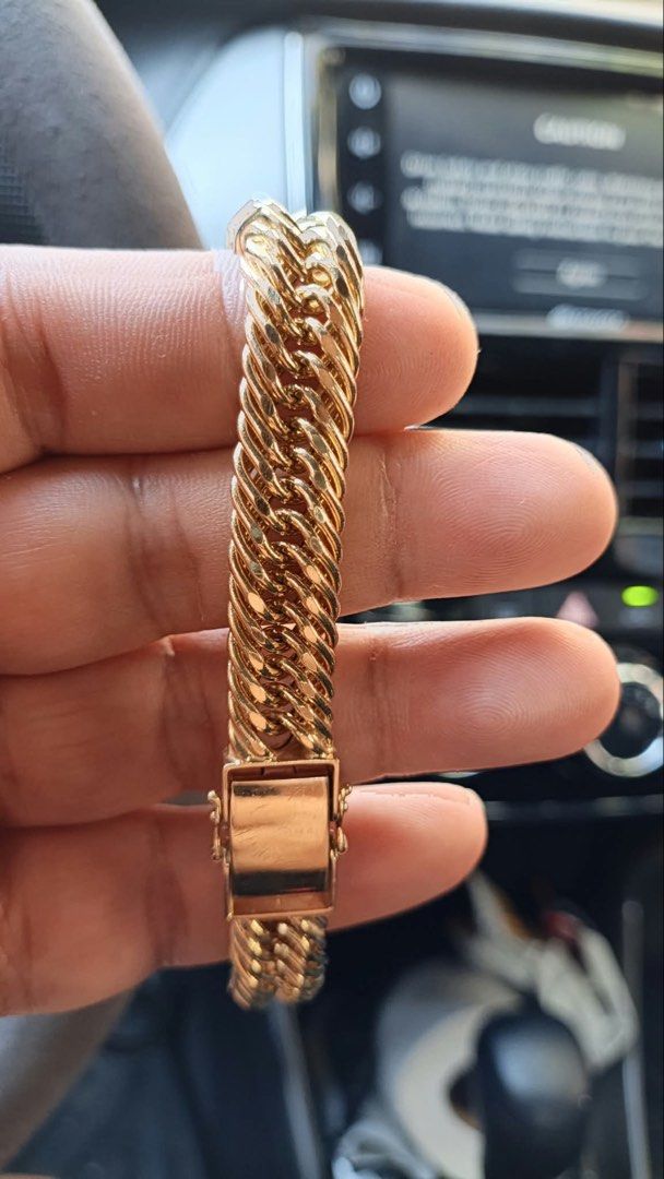 Gold Cuban Link Chain Bracelet with Clasp (Category: Jewelry) located in Manila. Submitted by shemineforever (Listing ID 1466777068, Image 1). Description: - Style: Classic chunky gold-tone curb link bracelet - Design: Heavy interlocking pattern with polished links - Closure: Secure box clasp on the end - Condition: Worn a few times, with slight scuff marks on the clasp surface.