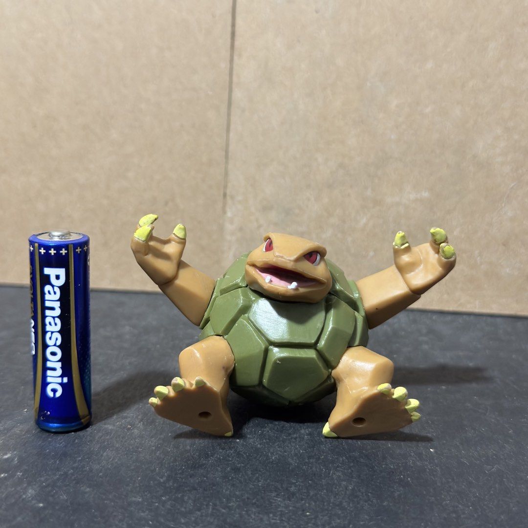 Golem Pokémon Figure 2007 Jakks Pacific (Category: Figurines & Statues) located in Cuyapo. Submitted by blacksheepshop (Listing ID 1466786925, Image 2). Description: Grotle Pokémon figure from 2007. Made by Jakks Pacific. Green shell and brown body with articulated arms. Stands around AA battery height for scale. Backstamp reads Nintendo and Jakks China. Some minor paint wear on the claws, normal for loose vintage toys. Great piece for a Pokémon 