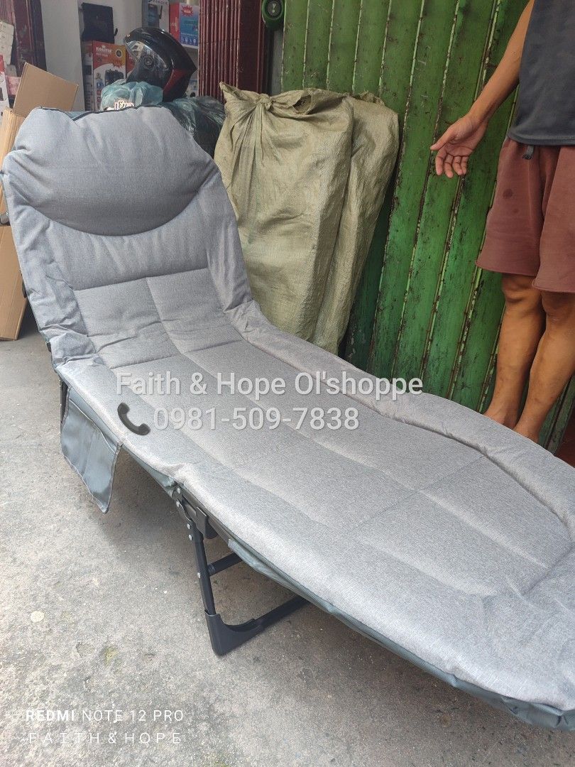 Gray Foldable Single Lounge Bed Recliner Cot (Category: Bed Frames & Mattresses) located in Manila. Submitted by jamfrimzy089458 (Listing ID 1466796952, Image 2). Description: - Versatile gray foldable lounge bed ideal for guests, office naps, or relaxing outdoors - Adjustable backrest transitions easily from sitting to a full flat sleeping position - Thick padded cushion for ultimate comfort - Built-in side pocket to keep your phone, books, or e