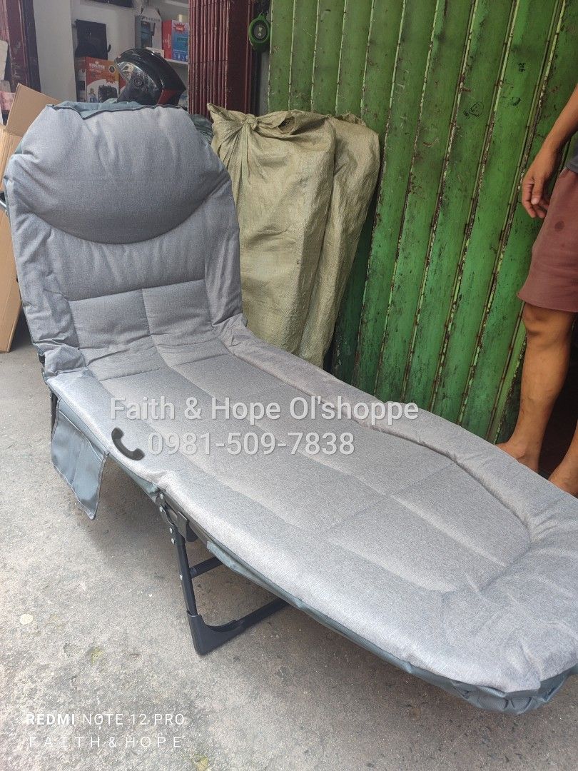 Gray Foldable Single Lounge Bed Recliner Cot (Category: Bed Frames & Mattresses) located in Manila. Submitted by jamfrimzy089458 (Listing ID 1466796952, Image 1). Description: - Versatile gray foldable lounge bed ideal for guests, office naps, or relaxing outdoors - Adjustable backrest transitions easily from sitting to a full flat sleeping position - Thick padded cushion for ultimate comfort - Built-in side pocket to keep your phone, books, or e