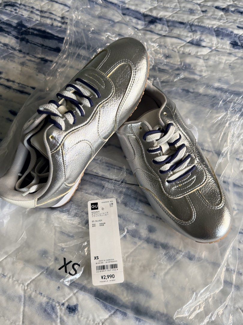 GU Silver Double Shoelace Flat Sneakers Size XS (Category: Sneakers) located in Marikina City. Submitted by themissusdeclutters (Listing ID 1466850014, Image 1). Description: - Brand: GU (Japan bought) - Flat sneakers in silver with white and dark blue double shoelaces - Size: XS (fits 22.0 cm) - JP 22 / EU 34 / US 5 per inner tag - Synthetic leather upper with durable rubber soles - Brand new, never worn, still in original plastic packaging - Ti