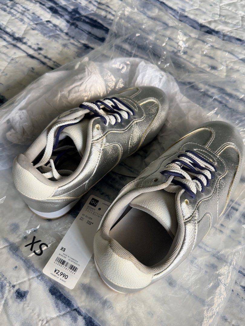 GU Silver Double Shoelace Flat Sneakers Size XS (Category: Sneakers) located in Marikina City. Submitted by themissusdeclutters (Listing ID 1466850014, Image 2). Description: - Brand: GU (Japan bought) - Flat sneakers in silver with white and dark blue double shoelaces - Size: XS (fits 22.0 cm) - JP 22 / EU 34 / US 5 per inner tag - Synthetic leather upper with durable rubber soles - Brand new, never worn, still in original plastic packaging - Ti