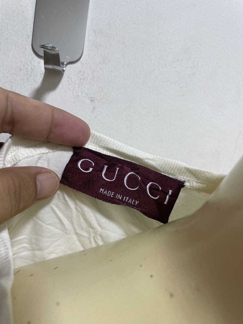 Gucci White T-Shirt (Category: Shirts) located in Santiago. Submitted by UkayLuxxSelector (Listing ID 1466795599, Image 2). Description: - Authentic Gucci T-shirt - Size: Medium (Made in Italy) - Color: White - Material: 100% cotton with a unique crinkled texture - Design: Classic crew neck, short sleeves, with signature burgundy collar label - Condition: Great everyday basic, easy to style - Mode of Payment: GCash - Shipping: Via J&T or Flash Ex