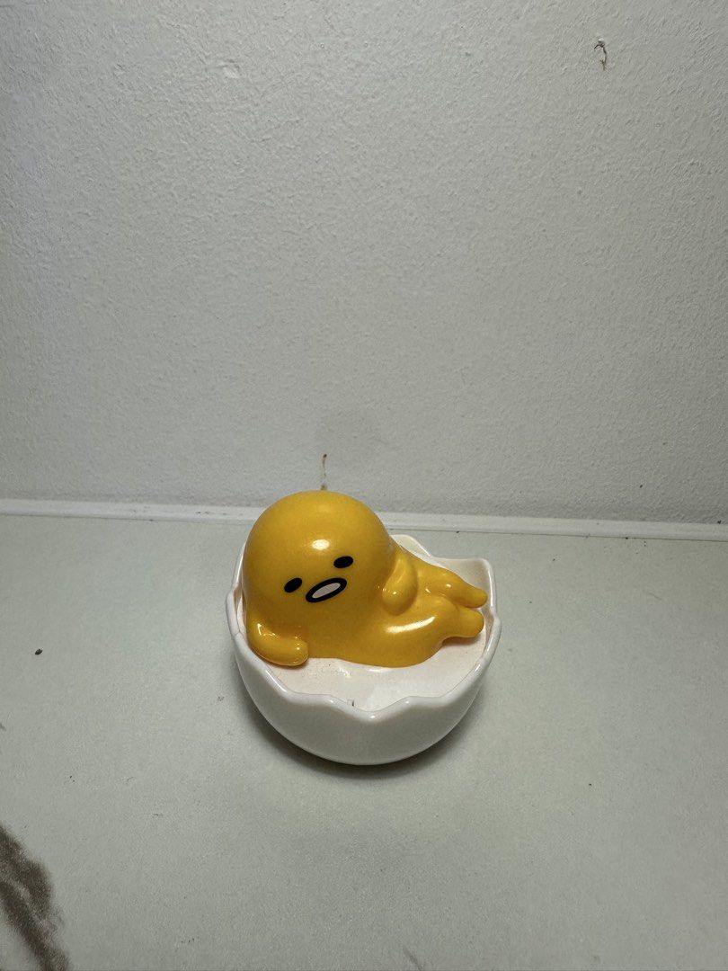 Gudetama Sanrio Lazy Egg Figurine in Eggshell (Category: Designer & Blind Box Toys) located in Quezon City. Submitted by swift.thriftz (Listing ID 1466887499, Image 1). Description: - Character: Sanrio Gudetama in a white cracked eggshell - Material: High-quality glossy ceramic - Design: Classic lazy egg bored facial expression - Use: Fun desk accessory, shelf decor, or collectible - Origin: Authentic Sanrio blind box/store item - Condition: Bran