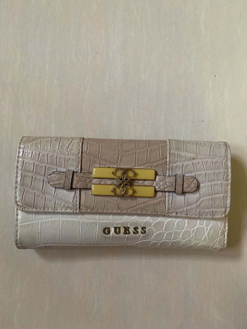 Guess Crocodile Pattern Long Wallet Off-White Beige (Category: Wallets & Card holders) located in Tiaong. Submitted by cdoswan (Listing ID 1466820424, Image 1). Description: HEARING OFFERS!! - Authentic-style GUESS long wallet in off-white & beige crocodile-embossed faux leather - Elegant gold-tone front logo with decorative strap & buckle detail - Secure snap button closure - Multiple card slots & clear ID window inside - Zippered coin compartme