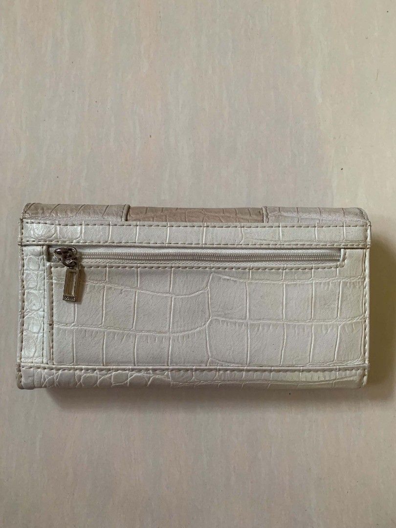 Guess Crocodile Pattern Long Wallet Off-White Beige (Category: Wallets & Card holders) located in Tiaong. Submitted by cdoswan (Listing ID 1466820424, Image 2). Description: HEARING OFFERS!! - Authentic-style GUESS long wallet in off-white & beige crocodile-embossed faux leather - Elegant gold-tone front logo with decorative strap & buckle detail - Secure snap button closure - Multiple card slots & clear ID window inside - Zippered coin compartme