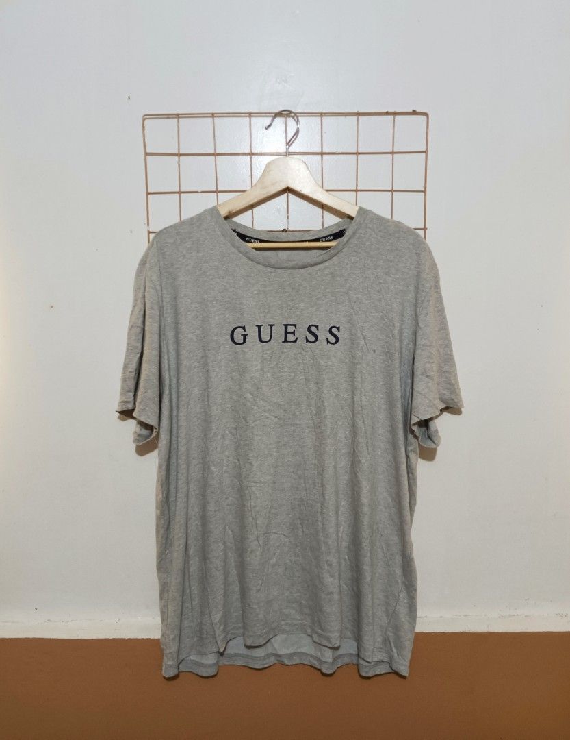 Guess Grey Logo T-Shirt Size 100 (Category: Tshirts & Polo Shirts ) located in Davao. Submitted by jasondagam14678 (Listing ID 1466784563, Image 1). Description: - Brand: Guess - Color: Grey - Size: 100 (Chest: 100cm) - Material: Cotton, polyester, and polyurethane blend - Fit: Regular fit, lightweight, and breathable - Design: Short sleeves, round neckline, small chest logo print, and branded inner neck taping - Condition: Brand new / Excellent 