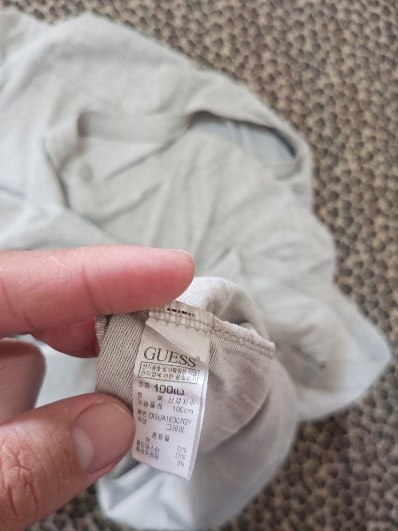 Guess Grey Logo T-Shirt Size 100 (Category: Tshirts & Polo Shirts ) located in Davao. Submitted by jasondagam14678 (Listing ID 1466784563, Image 2). Description: - Brand: Guess - Color: Grey - Size: 100 (Chest: 100cm) - Material: Cotton, polyester, and polyurethane blend - Fit: Regular fit, lightweight, and breathable - Design: Short sleeves, round neckline, small chest logo print, and branded inner neck taping - Condition: Brand new / Excellent 