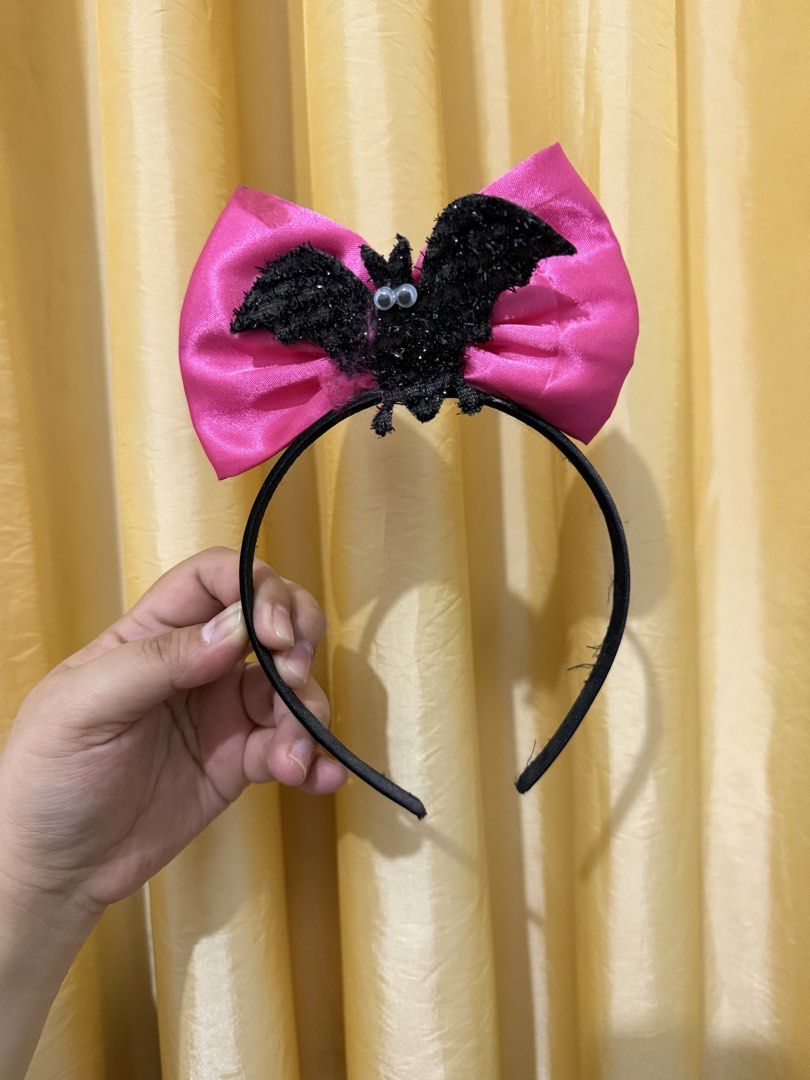 Halloween Bat Headband with Pink Bow (Category: Hair Accessories) located in Binan City. Submitted by prelovedlagunaph (Listing ID 1466968162, Image 1). Description: - Design: Black headband featuring a large shiny pink satin bow - Accent: Centered fuzzy black glitter bat with funny googly eyes - Perfect for: Costume parties, Halloween, and spooky season events - Fit: Comfortable on most head sizes - Condition: Clean fabric, well-stored.