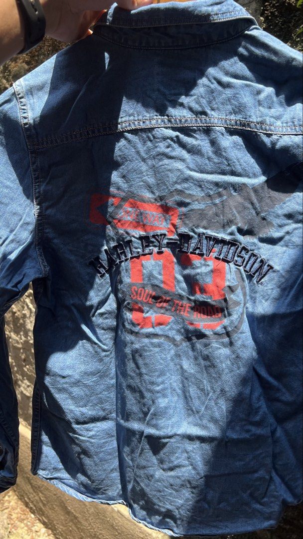 Harley Davidson Denim Shirt Long Sleeve (Category: Coats, Jackets and Outerwear) located in Manila. Submitted by thrift_cass (Listing ID 1466859451, Image 2). Description: - Brand: Harley-Davidson - Style: Long sleeve denim shirt / button-down - Color: Blue wash - Design: 'Soul of the Road' graphic print and embroidery on the back - Features: Standard collar, single chest pocket, button cuffs - Fit: Standard fit - Condition: Great for casual wear