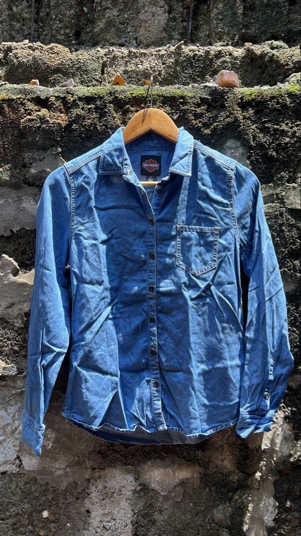Harley Davidson Denim Shirt Long Sleeve (Category: Coats, Jackets and Outerwear) located in Manila. Submitted by thrift_cass (Listing ID 1466859451, Image 1). Description: - Brand: Harley-Davidson - Style: Long sleeve denim shirt / button-down - Color: Blue wash - Design: 'Soul of the Road' graphic print and embroidery on the back - Features: Standard collar, single chest pocket, button cuffs - Fit: Standard fit - Condition: Great for casual wear