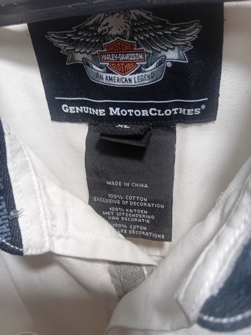Harley Davidson Genuine Clothes Button-Up Shirt White (Category: Tshirts & Polo Shirts ) located in Manila. Submitted by newfish_883539 (Listing ID 1466870831, Image 2). Description: Brand: Harley-Davidson (Genuine Clothes / An American Legend line) Size: XL (Extra Large) Color: Cream / Off-White Material: 100% Premium Cotton Key Features: • Left chest: Embroidered retro circular Harley-Davidson Motorcycles logo. • Upper back: Stitched Harley-Dav
