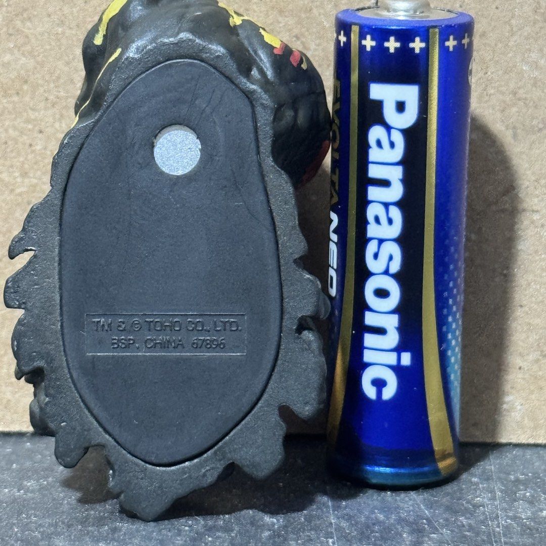 Hedorah Magnet Toho Godzilla Figure (Category: Figurines & Statues) located in Cuyapo. Submitted by blacksheepshop (Listing ID 1466778067, Image 2). Description: - Character: Hedorah (Official Toho Co. Ltd) - Size: Tiny, around the size of an AA battery - Features: Black, red, and yellow paint details with a built-in bottom magnet - Authenticity: Includes molded official Toho stamp and BSP China 67896 marking - Condition: Clean surface and well-m