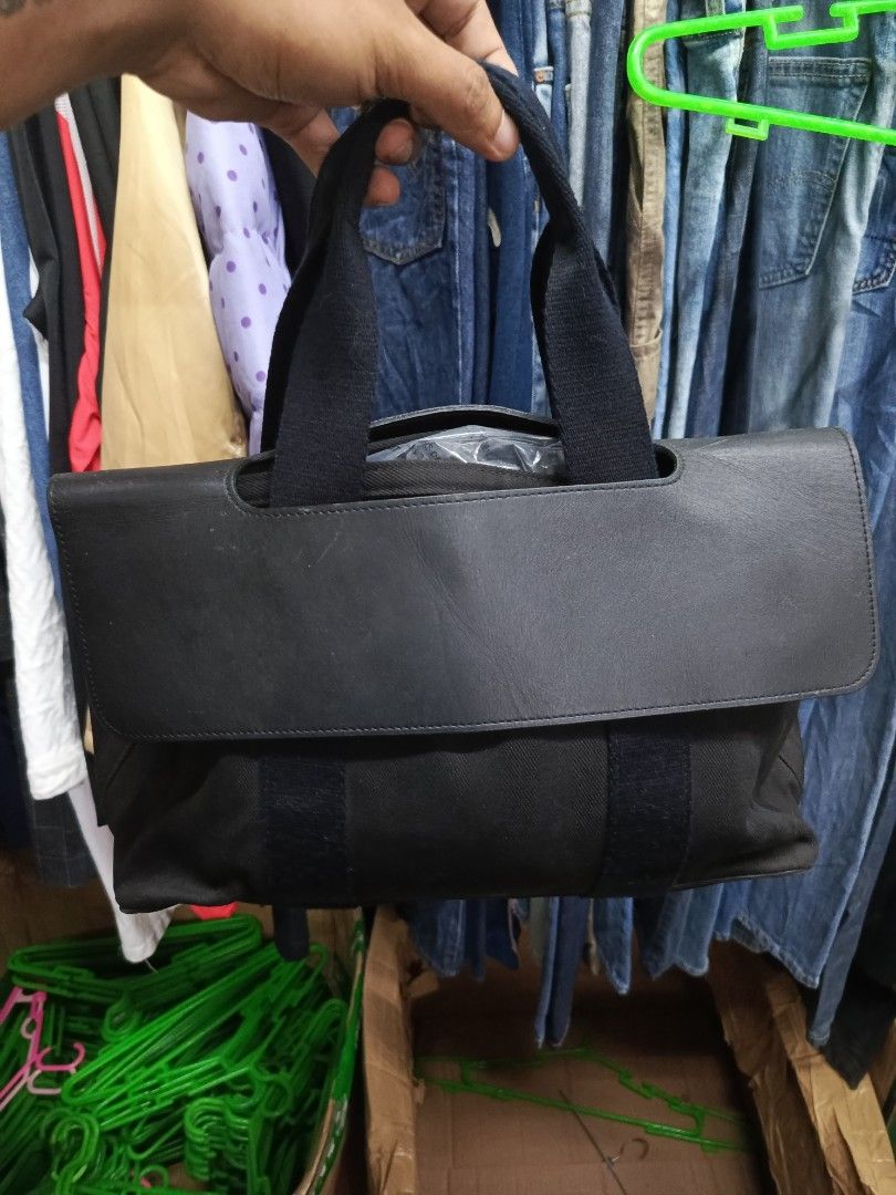 Hermès Black Canvas Leather Tote Bag (Category: Tote Bags) located in Cabatuan. Submitted by penthegreat (Listing ID 1466784827, Image 1). Description: - Brand: Hermès - Material: Black canvas body with premium leather flap top and double handles - Hardware: Silver-tone with engraved branding on snap buttons - Interior: Spacious layout with multiple pockets and convenient key clips - Style: Classic, versatile dark colorway ideal for everyday esse