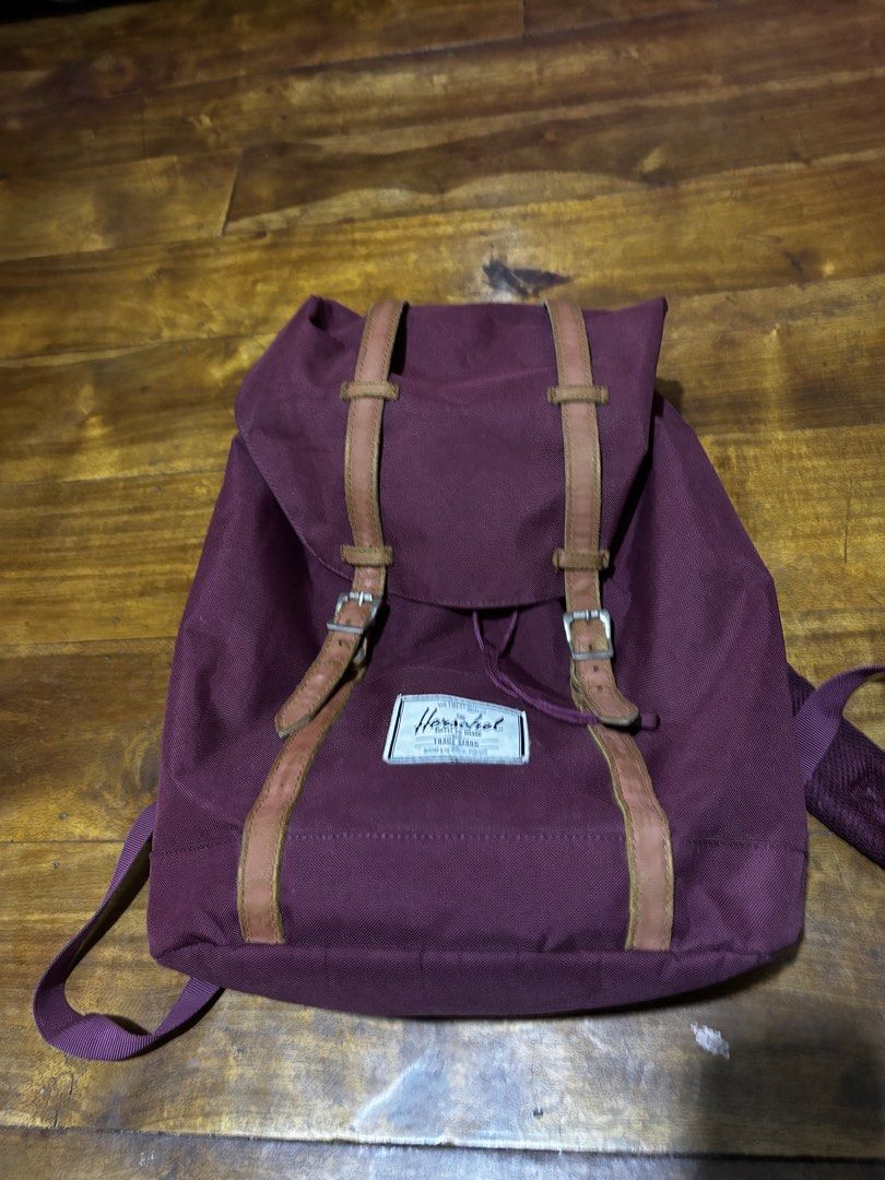 Herschel Maroon Backpack with Brown Straps (Category: Backpacks) located in Malaybalay. Submitted by ziggyy. (Listing ID 1466865472, Image 1). Description: - Authentic maroon Herschel backpack - Features durable canvas material with brown faux leather straps and metal buckles - Secure drawstring closure under the main flap - Signature red and white striped fabric interior lining - Adjustable, padded shoulder straps for all-day comfort - Clean ext