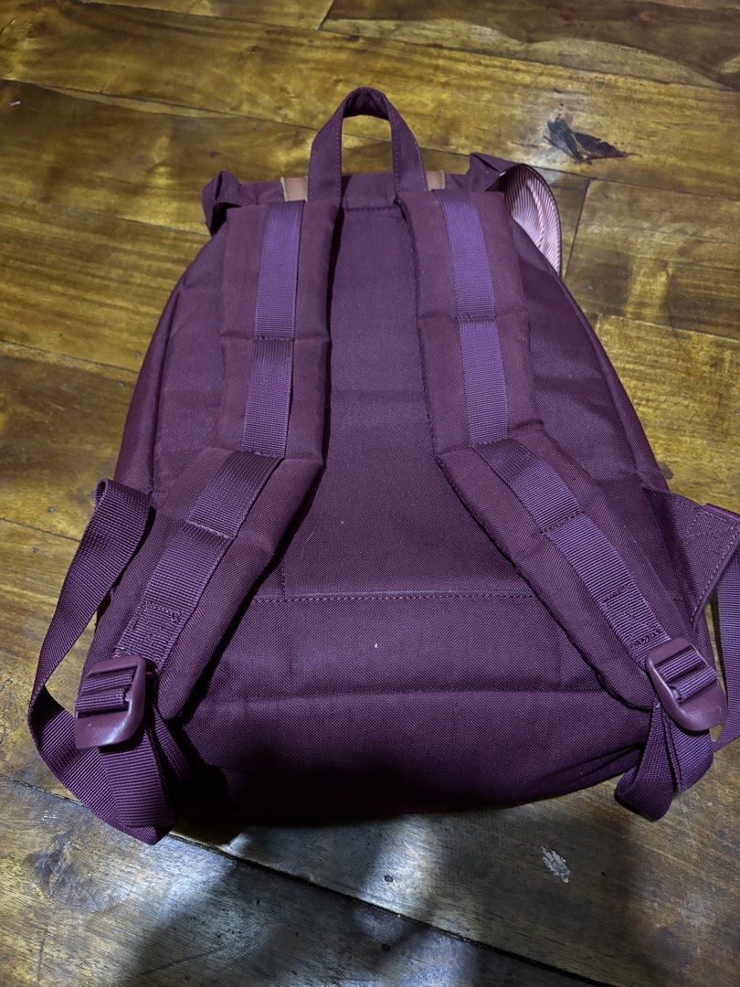 Herschel Maroon Backpack with Brown Straps (Category: Backpacks) located in Malaybalay. Submitted by ziggyy. (Listing ID 1466865472, Image 2). Description: - Authentic maroon Herschel backpack - Features durable canvas material with brown faux leather straps and metal buckles - Secure drawstring closure under the main flap - Signature red and white striped fabric interior lining - Adjustable, padded shoulder straps for all-day comfort - Clean ext