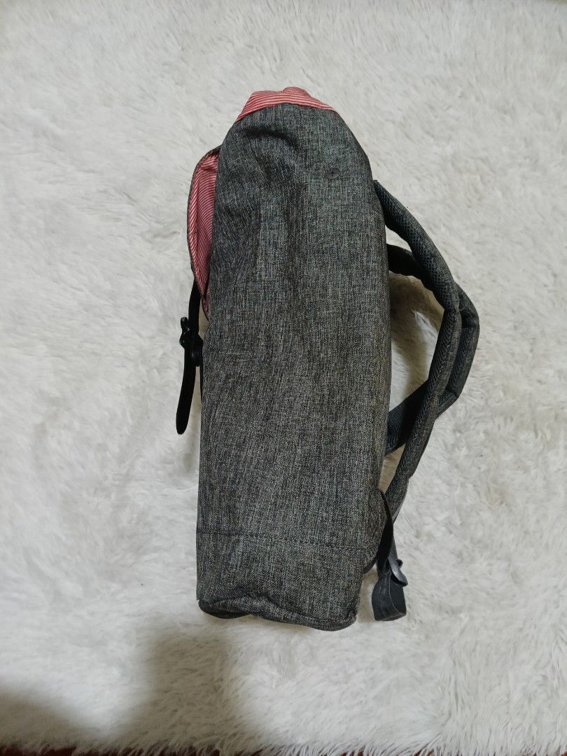 Herschel Supply Co. Grey Backpack (Category: Backpacks) located in Quezon City. Submitted by jdwoah12 (Listing ID 1466819953, Image 2). Description: Grey heather fabric backpack from Herschel. Signature red and white striped interior lining. Dual black faux-leather straps with metal pin buckles and magnetic closures. Padded adjustable shoulder straps on the back. Roomy main compartment for daily essentials, school, or work. Clean exterior and int
