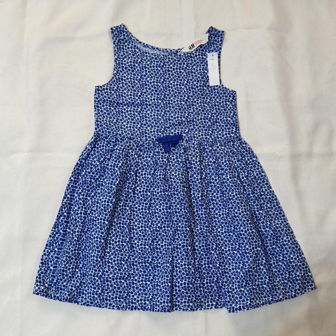 H&M Blue and White Patterned Dress (Category: Babies & Kids Fashion) located in Paranaque City. Submitted by dionne_bird (Listing ID 1466930194, Image 1). Description: - Brand: H&M - Color: Blue and white with all-over textured pattern - Style: Sleeveless dress with fitted bodice and flared pleated skirt - Details: Cute small blue bow at the waist - Condition: Brand new with tag attached near neckline, clean, and ready to wear.
