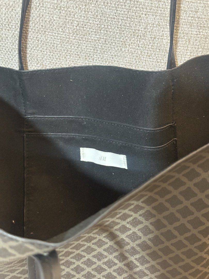 H&M Patterned Tote Bag (Category: Tote Bags) located in Makati City. Submitted by biancak20 (Listing ID 1466814119, Image 2). Description: - Brand: H&M - Design: Dark geometric pattern with black piping - Straps: Comfortable black shoulder straps - Interior: Black fabric lining with convenient slip pocket and H&M brand tag - Usage: Spacious everyday bag, perfect for daily essentials.