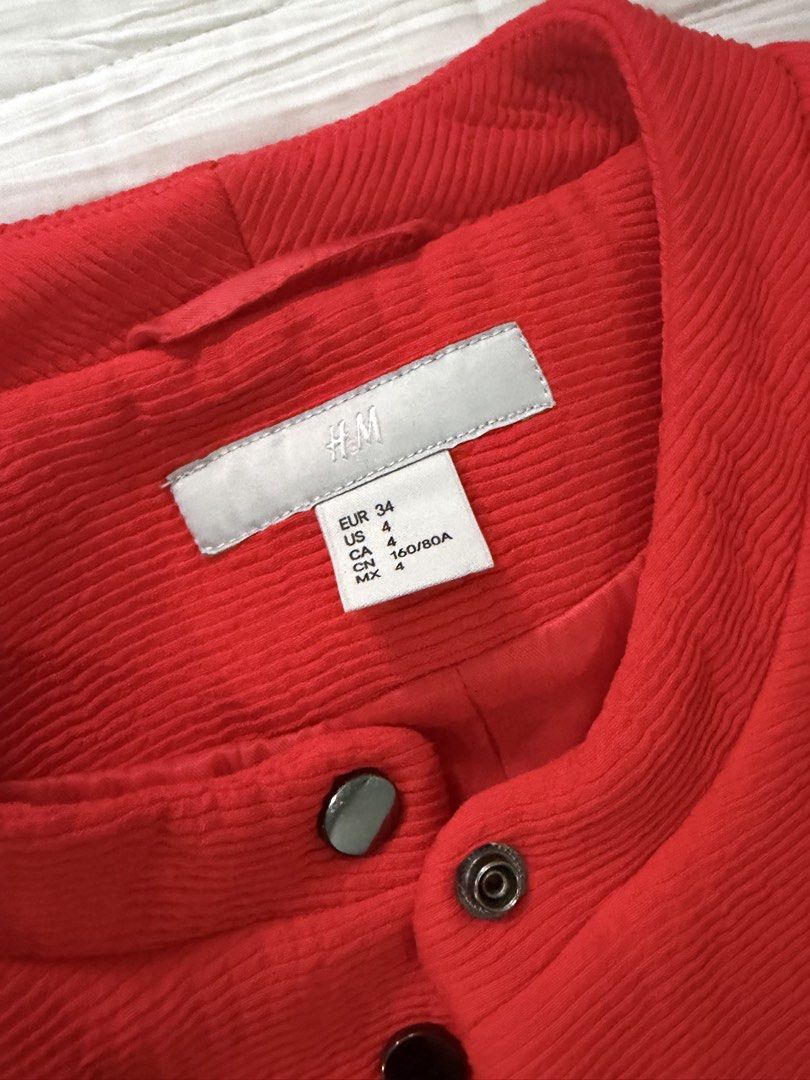 H&M Red Textured Button-Up Jacket EUR 34 US 4 (Category: Coats, Jackets and Outerwear) located in Quezon City. Submitted by afternoonstore (Listing ID 1466840991, Image 3). Description: - Brand: H&M - Color: Vibrant Red - Size: EUR 34 / US 4 / CN 160/80A - Material/Design: Textured weave pattern with full lining - Features: Round neckline and front snap button closure - Condition: Clean and well-maintained.
