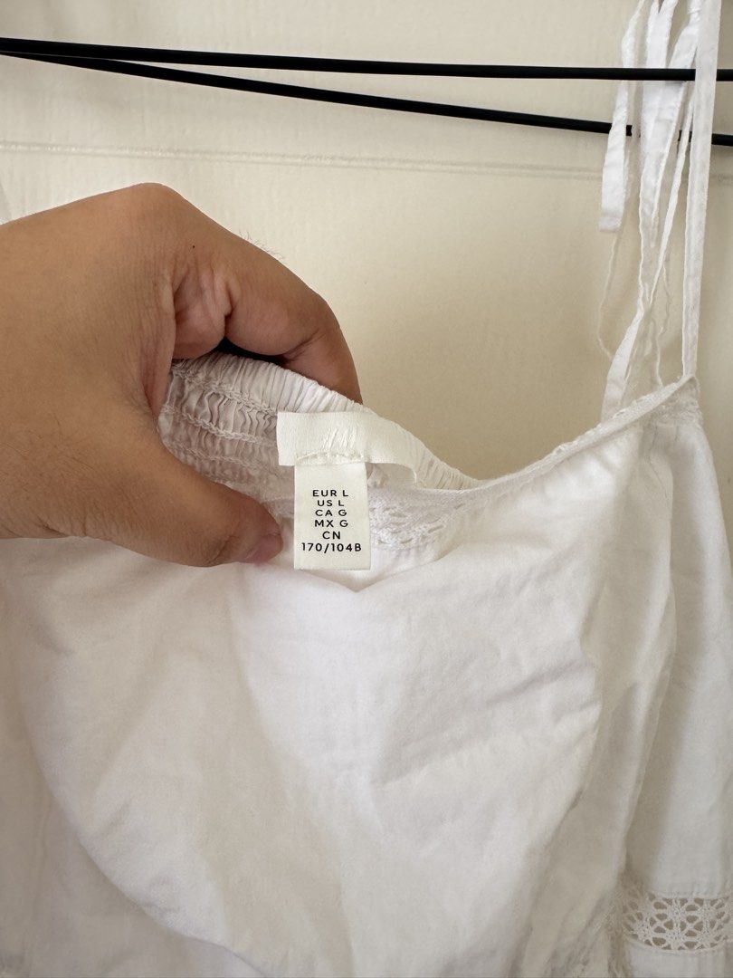 H&M White Spaghetti Strap Midi Dress Size L (Category: Dresses) located in Mandaluyong City. Submitted by trinket.ph (Listing ID 1466774615, Image 2). Description: - Used once only for birthday trip - Brand: H&M - Color: White - Size: L (170/104B) - Features: Tie-up straps, delicate lace trim around bodice and waist, flared skirt, lightweight midi-length fabric - Best for: Casual outings, vacations, and effortless styling.