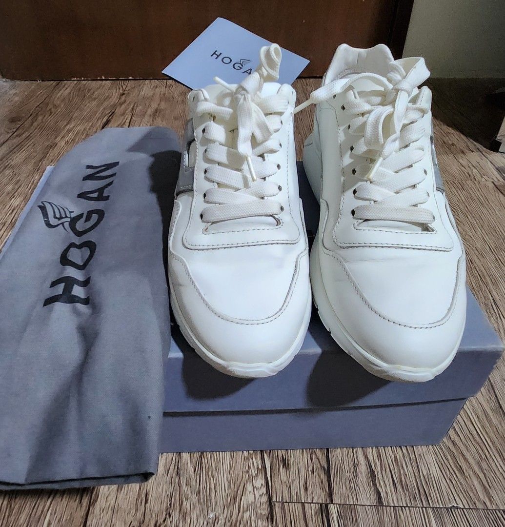 Hogan Interactive (Category: Sneakers) located in Taytay. Submitted by luxebagcray (Listing ID 1466879045, Image 2). Description: - Brand: Hogan - Color: White leather with silver and cream details - Features: Silver side logo (with visible cracking on metallic finish), white laces, chunky rubber soles - Condition: Minor dirt marks on insoles from wear - Inclusions: Original blue box, dust bag, and brand card - Original price is 11k.