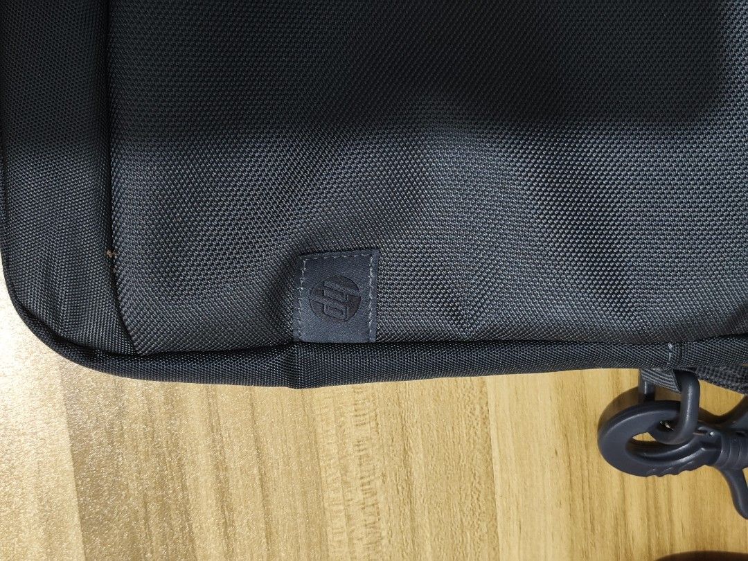 HP Black Laptop Shoulder Bag (Category: Laptop Bags & Sleeves) located in Taytay. Submitted by goldentree-b9df (Listing ID 1466925890, Image 2). Description: - Authentic black HP laptop bag, ideal for daily work or school commutes - Durable nylon exterior featuring a subtle HP logo tag - Main zippered compartment with a padded section and velcro strap for secure device storage - Front section equipped with multiple slip pockets and pen holders fo