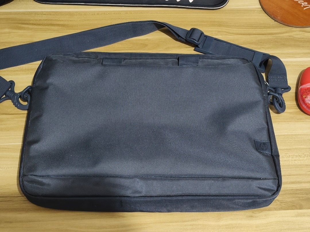 HP Black Laptop Shoulder Bag (Category: Laptop Bags & Sleeves) located in Taytay. Submitted by goldentree-b9df (Listing ID 1466925890, Image 1). Description: - Authentic black HP laptop bag, ideal for daily work or school commutes - Durable nylon exterior featuring a subtle HP logo tag - Main zippered compartment with a padded section and velcro strap for secure device storage - Front section equipped with multiple slip pockets and pen holders fo