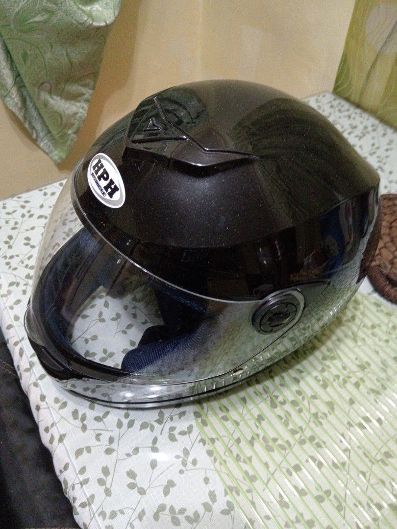 HPH Full Face Motorcycle Helmet Black (Category: Caps & Hats) located in Quezon City. Submitted by mylittlebaby2525 (Listing ID 1466895665, Image 3). Description: - Brand/Model: HPH Full Face Motorcycle Helmet - Finish: Sleek glossy black with a clear visor - Ventilation: Top air vent on the crown for airflow - Comfort: Padded interior lining - Closure: Standard secure strap underneath - Condition: Clean exterior with minimal wear, perfect as a s