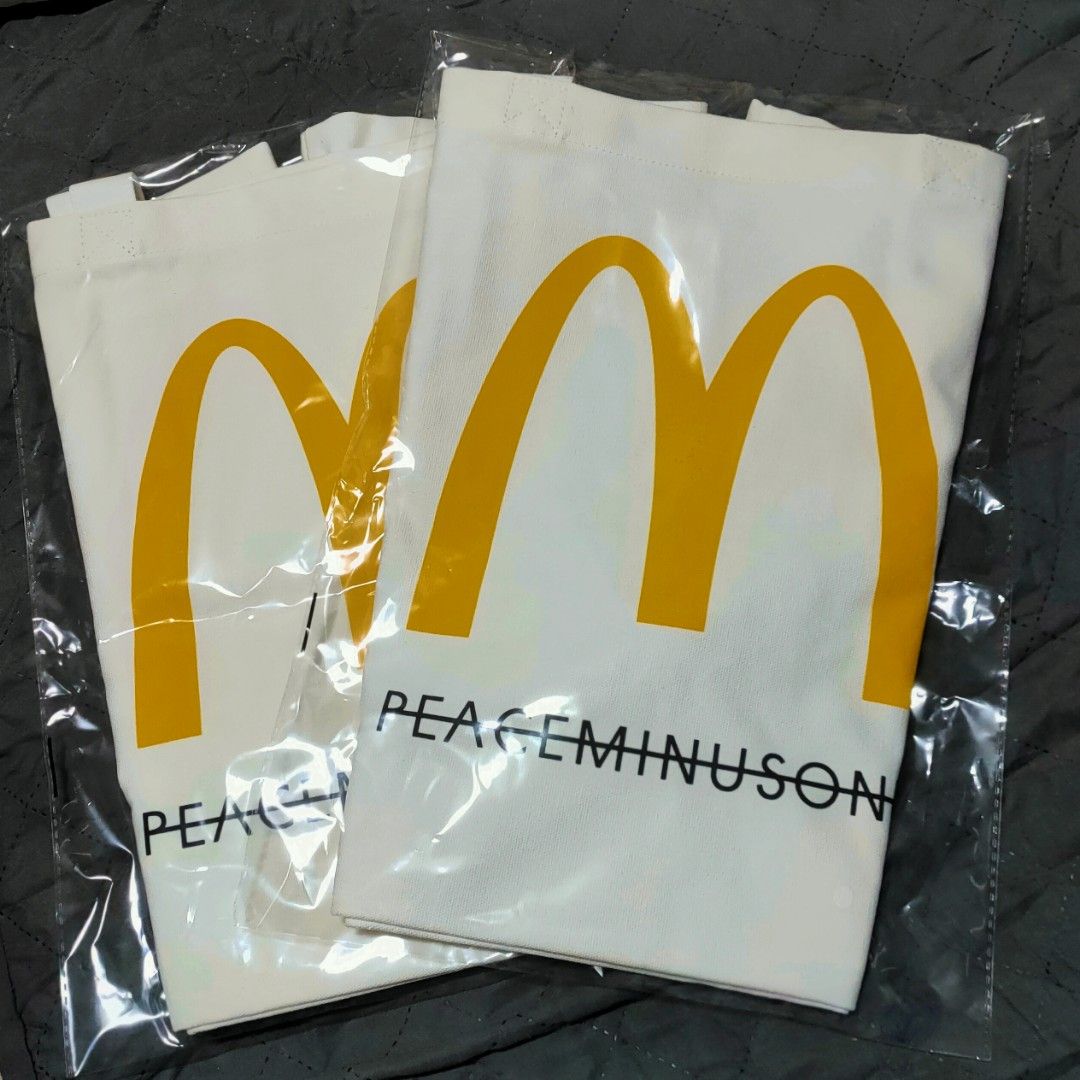[ICONIC] McDonald's x PEACEMINUSONE Tote Bag (Category: Tote Bags) located in Singapore. Submitted by nofrillsfactoryoutlet (Listing ID 1466936076, Image 5). Description: 100% Authentic and Brand New in Packaging. ⭐Brand : MacDonald's X PEACEMINUSONE ⭐Type : Tote Bag ⭐Colour : Cream White ⭐Self-Collection : Kadaloor LRT / Punggol MRT ⭐Postage : SMARTPAC to letterbox ⚡ DIMENSIONS (Approx)⚡ - 52*36*43cm - Double Handle drop : 27cm ⚡KEY FEATURES⚡ - 