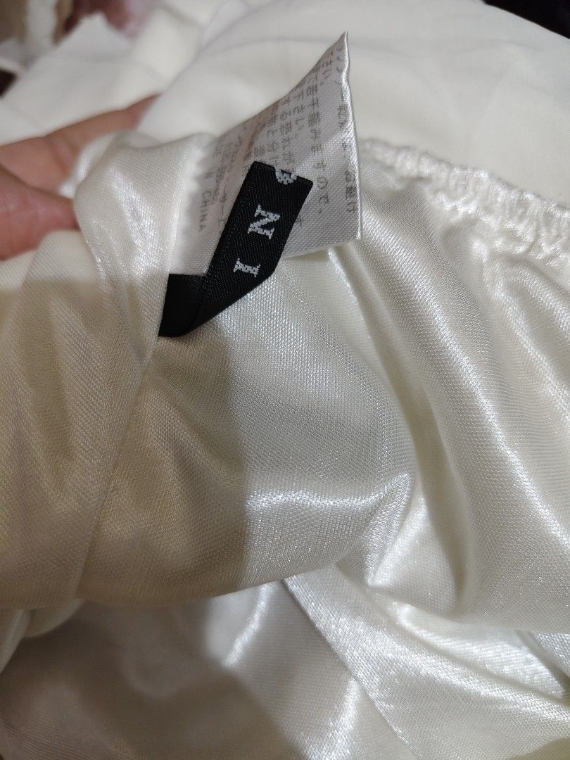 IGNI White Off Shoulder Ruffle Blouse Top (Category: Blouses) located in Manila. Submitted by chynii_28 (Listing ID 1466868355, Image 2). Description: - Brand: IGNI - Color: White - Style: Off-shoulder blouse with short layered flutter sleeves, gathered neckline, and ruffled hem - Material: Thick, flowy double lining for zero transparency and great movement - Sizing: Fits bust up to 38 inches and waist up to 36 inches - Condition: Excellent, no f