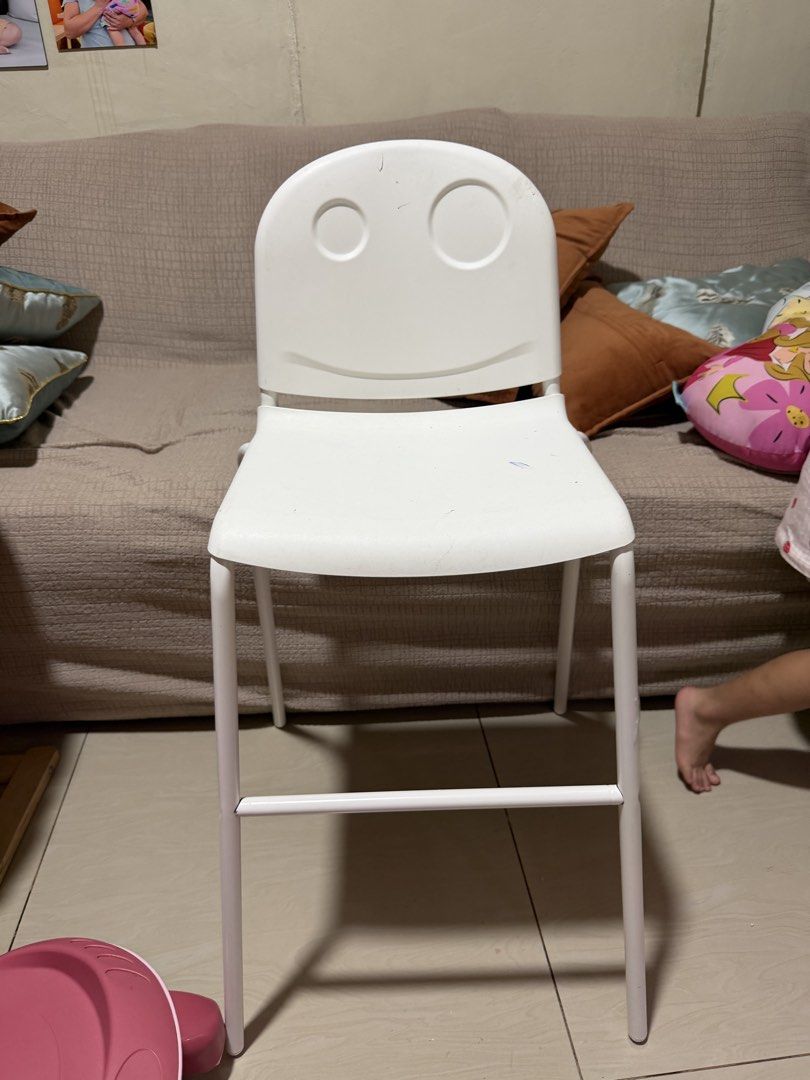 IKEA VILDGÄS Childrens High Chair (Category: Baby High Chairs) located in Manila. Submitted by heartprints (Listing ID 1466845757, Image 1). Description: - Brand: IKEA VILDGAS High Chair - Color: Classic White with a cute smiley face design on the backrest - Frame: Sturdy metal legs with a convenient footrest bar - Condition: Structurally solid and safe for meals - Flaws: Visible scuffs and blue ink marks on the seat and back from regular kid use