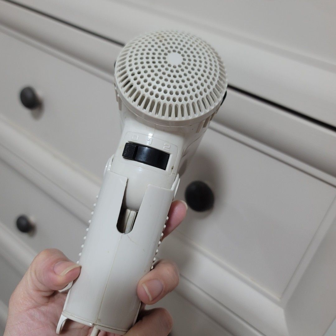 Imarflex Foldable Hair Dryer White (Category: Hair) located in Pasig City. Submitted by bunny.bella (Listing ID 1466923744, Image 2). Description: - Brand: Imarflex - Color: White - Design: Compact size with a convenient foldable handle, ideal for travel - Settings: Dual speed settings with an easy-to-use black switch - Condition: Fully functional and powers on well, with normal signs of use and slight body discoloration - Features: Circular rear