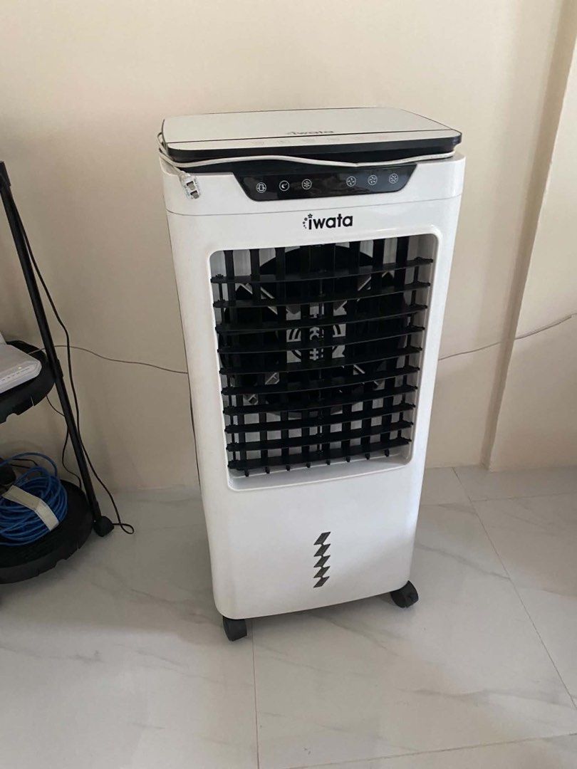 Iwata Air Cooler x100r (Category: Air Conditioning and Heating) located in Cavite. Submitted by argeteherbert03 (Listing ID 1466948158, Image 3). Description: - Brand: Iwata - Color: White body with black front grille and control panel - Controls: Digital touch buttons on top panel (Swing, Breeze, Timer, Cool, Speed functions) - Water Refill: Convenient top-opening water compartment for easy filling - Portability: Mounted on smooth caster wheels 