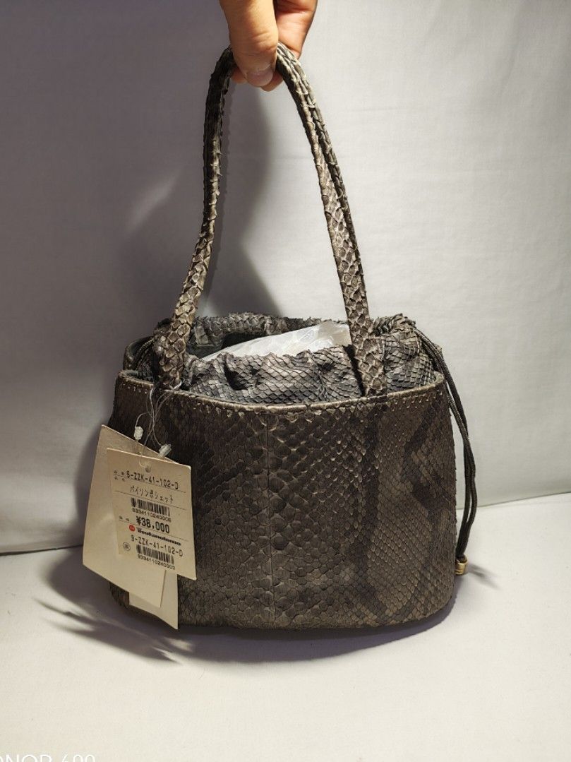📣ON SALE‼️FROM 4800 TO 4200‼️JAPAN TSUKIOKAMOTO GENUINE REAL AUTHENTIC PYTHON SNAKESKIN SMALL BUCKET BAG HANDBAG (Category: Luxury Bags & Wallets) located in Quezon City. Submitted by sparkys.joy_88 (Listing ID 1466883147, Image 1). Description: - Brand: Tsukiokamoto - Material: Genuine python snakeskin with natural scale texture - Color: Grey and dark tones - Design: Bucket bag style with dual top handles and inner drawstring pouch - Condition:
