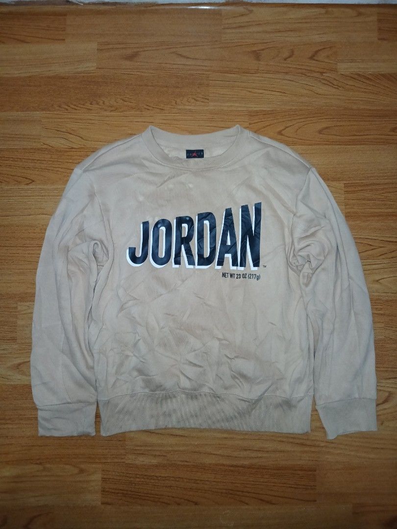 Jordan Beige Long Sleeve Sweatshirt (Category: Babies & Kids Fashion) located in General Santos City (Dadiangas). Submitted by afsph1996 (Listing ID 1466859851, Image 1). Description: - Brand: Jordan - Color: Beige - Size: Medium (M) 150/72 -Dimes 18W 22L - Design: Large black vertical Jordan text graphic on the chest - Special Detail: Michael Jordan signature embroidery on the back shoulder - Interior: Black collar tag featuring the iconic red J