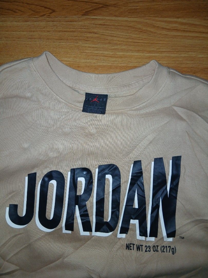 Jordan Beige Long Sleeve Sweatshirt (Category: Babies & Kids Fashion) located in General Santos City (Dadiangas). Submitted by afsph1996 (Listing ID 1466859851, Image 3). Description: - Brand: Jordan - Color: Beige - Size: Medium (M) 150/72 -Dimes 18W 22L - Design: Large black vertical Jordan text graphic on the chest - Special Detail: Michael Jordan signature embroidery on the back shoulder - Interior: Black collar tag featuring the iconic red J