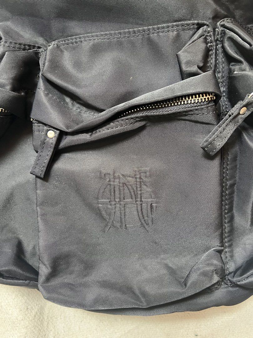 JPG Paris Black Nylon Drawstring Backpack (Category: Backpacks) located in Cagayan de Oro. Submitted by nelsondel21723 (Listing ID 1466910339, Image 2). Description: - Brand/Model: JPG Paris Black Nylon Backpack - Closure: Drawstring closure with adjustable straps for comfort - Pockets: Three exterior zipped utility pockets on the front and one interior zipped pocket - Details: Features an embroidered logo patch and woven interior brand label - M
