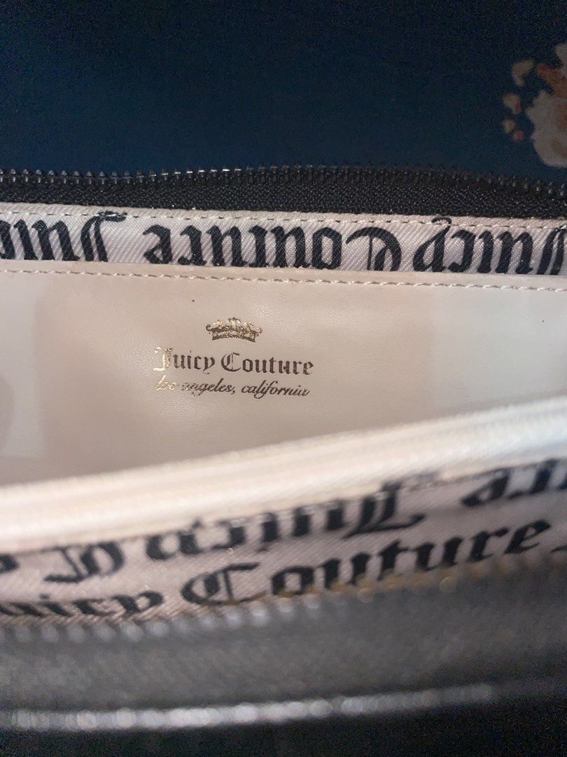 Juicy Couture Black Zip Around Wallet (Category: Wallets & Card holders) located in Manila. Submitted by uiiauiiauiauiiaui (Listing ID 1466838513, Image 1). Description: - Brand: Juicy Couture - Color: Classic Black with elegant gold-tone hardware - Design: Signature brand lettering plate on the front - Interior: Clean branded fabric lining - Organization: Multiple card slots, spacious bill compartments, and a secure zippered coin pocket - Condit