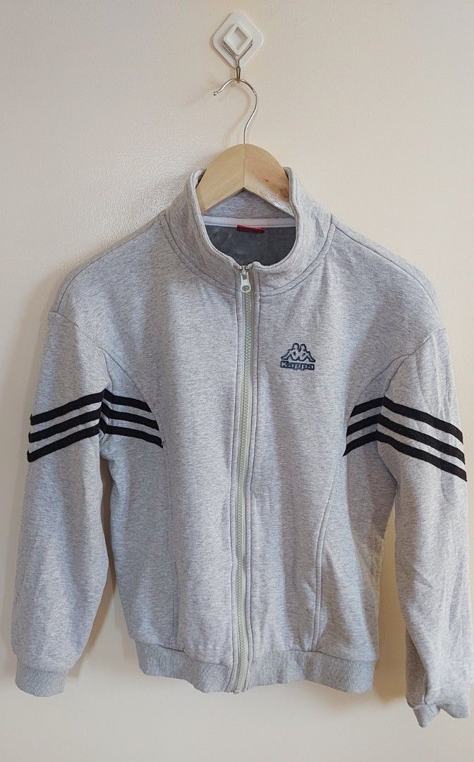 Kappa zip-up track jacket (Category: Activewear) located in Pozorrubio. Submitted by infinite_grind_0.1 (Listing ID 1466821256, Image 1). Description: 285 The a grey vintage Kappa zip-up track jacket with a high mock neck, a Kappa Omini logo embroidery on the chest, and triple black stripes on both sleeves on tape: chest 18 length 21.