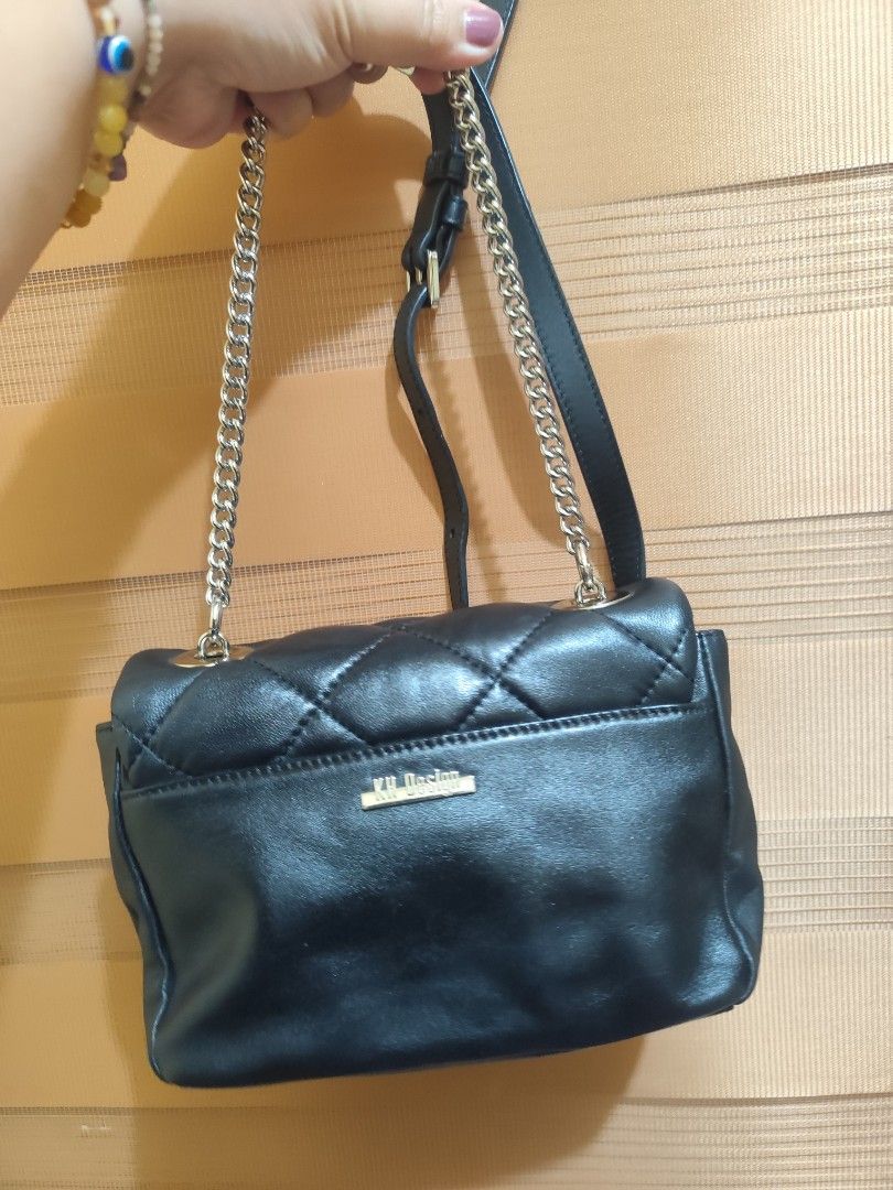 KH Design Quilted Black Shoulder Bag with Chain Strap (Category: Shoulder Bags) located in Naga. Submitted by semflewer (Listing ID 1466827117, Image 3). Description: - Brand: KH Design (Established 1995) - Color & Style: Black quilted shoulder bag with chic gold-toned hardware - Closure: Secure flap closure with a unique metal lock mechanism - Strap: Adjustable chain and leather combination for versatile wear - Exterior: Convenient back pocket f