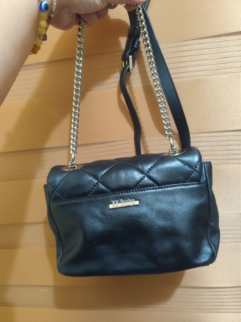 KH Design Quilted Black Shoulder Bag with Chain Strap (Category: Shoulder Bags) located in Naga. Submitted by semflewer (Listing ID 1466827117, Image 2). Description: - Brand: KH Design (Established 1995) - Color & Style: Black quilted shoulder bag with chic gold-toned hardware - Closure: Secure flap closure with a unique metal lock mechanism - Strap: Adjustable chain and leather combination for versatile wear - Exterior: Convenient back pocket f