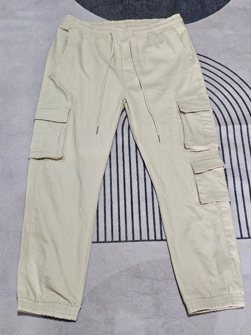 Khaki Cargo pants (Category: Jeans) located in Baguio. Submitted by kayeonlineshop (Listing ID 1466860022, Image 1). Description: beige/ecru drawstring cargo joggers feature side flap pockets and cuffed ankles. w28-34 l36.5 h6.8.