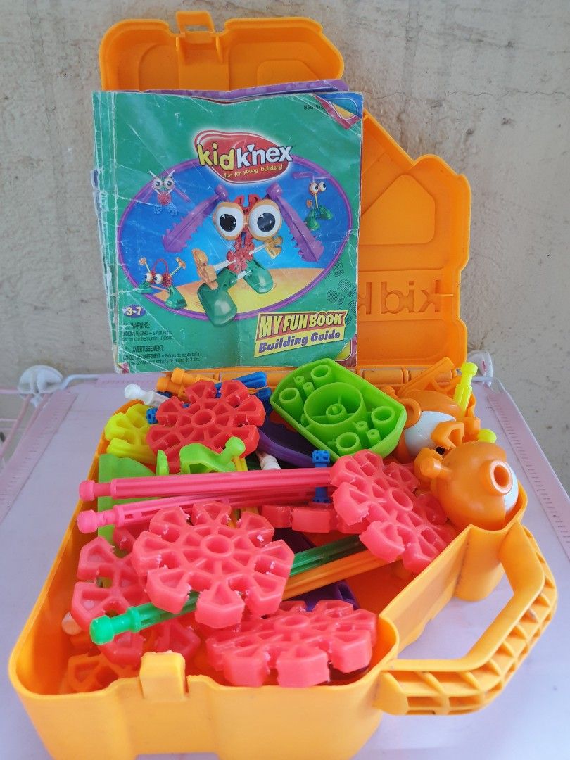 Kid K'Nex My Fun Book Building Set with Storage Case (Category: Educational & Learning Toys) located in Las Pinas. Submitted by anggesmart (Listing ID 1466785908, Image 2). Description: - Kid K'Nex starter building set for young kids - Includes colorful plastic pieces, gears, and connectors - Comes with 'My Fun Book' building guide - Convenient orange plastic storage case with a handle for easy cleanup and portability.