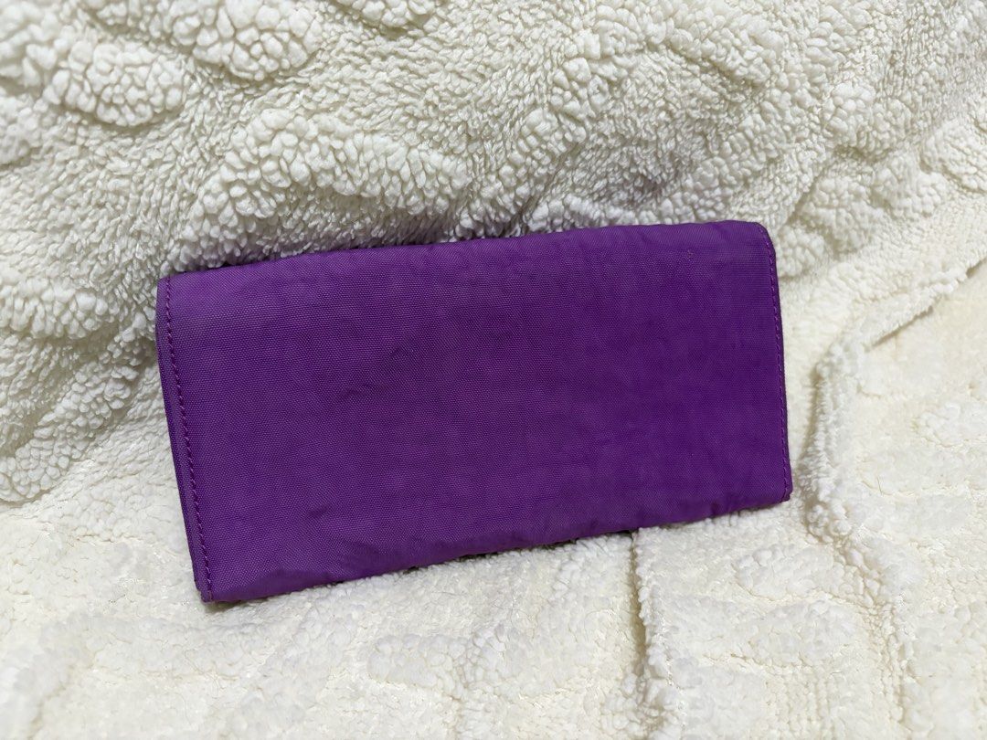 Kipling Purple Long Wallet (Category: Wallets & Card holders) located in Paranaque City. Submitted by greatfinds108 (Listing ID 1466823517, Image 2). Description: - Brand: Kipling - Color: Bright purple - Closure: Flap with snap buttons - Interior features: Multiple card slots, ID windows, and a zippered coin compartment - Lining: Cute heart pattern print - Condition: Clean interior and exterior - Capacity: Plenty of space for daily cards and cas