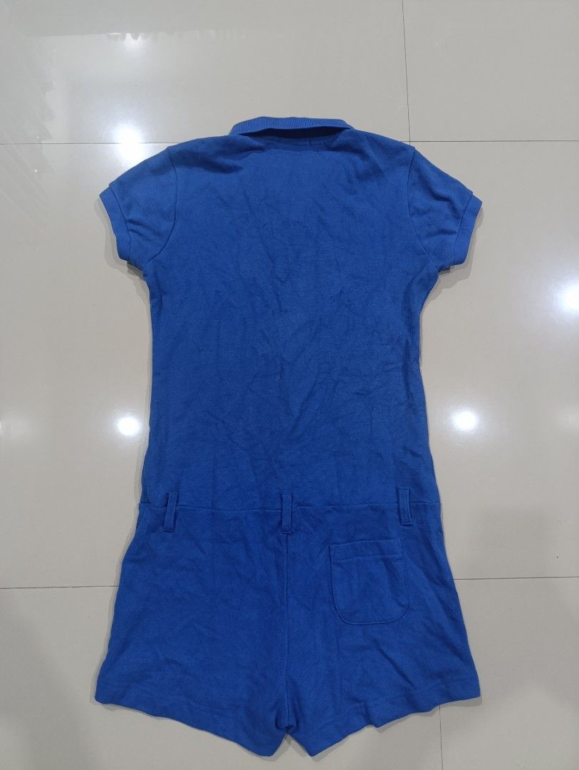 Lacoste Blue Polo Romper Playsuit Size 36 (Category: Rompers) located in Davao. Submitted by idioticthrifter (Listing ID 1466949037, Image 3). Description: - Brand: Lacoste - Style: Bright blue polo romper with built-in shorts and a back pocket - Size: 36 (tagged at the collar) - Material: Comfortable cotton and polyester blend with a loopback interior texture - Details: Short sleeves, front button placket, and signature embroidered green crocodi